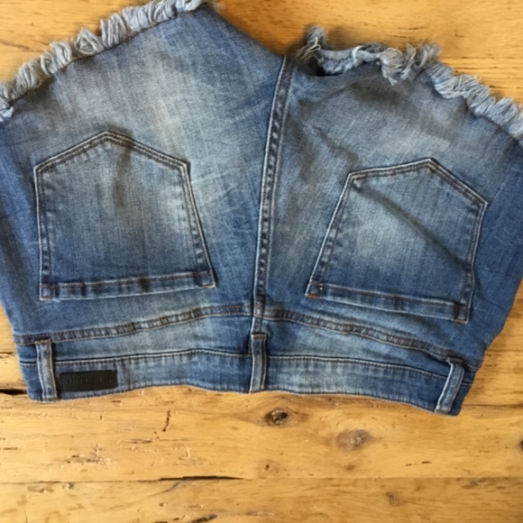 29” STS Blue jean shorts feature a distressed design with a dark blue wash - Picture 3 of 8